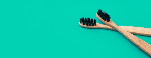 Wooden toothbrush on a green panoramic background