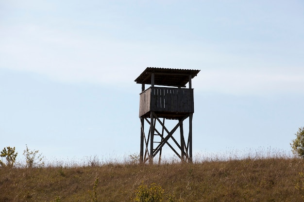 Wooden tower, located on a hill.