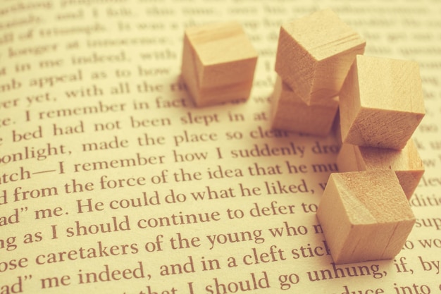 Photo wooden toy cubes placed on a book page