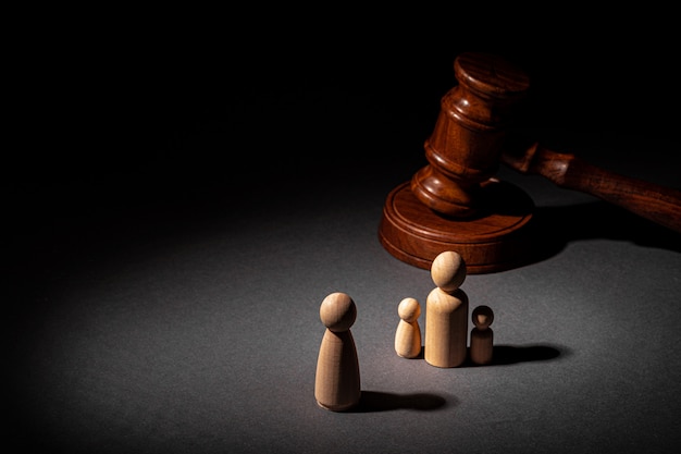 Wooden toy family and judge mallet. Family divorce concept