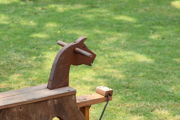 Photo wooden toy on grass at back yard