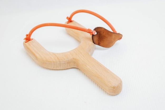 Wooden toy slingshot on white background