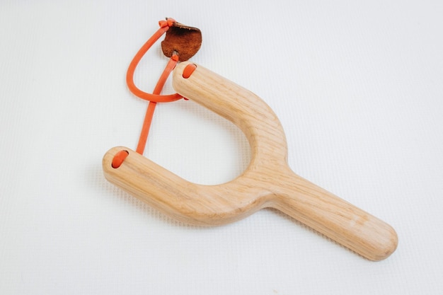 Wooden toy slingshot on white background