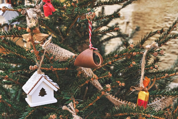 Photo wooden toys sweets leather baubles and dried fruit are natural decorations for the xmas tree