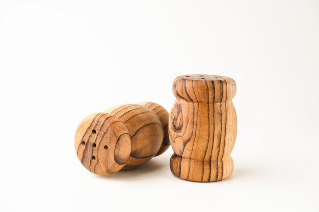 Wooden traditional salt and pepper shakers on white background selective focus copy space