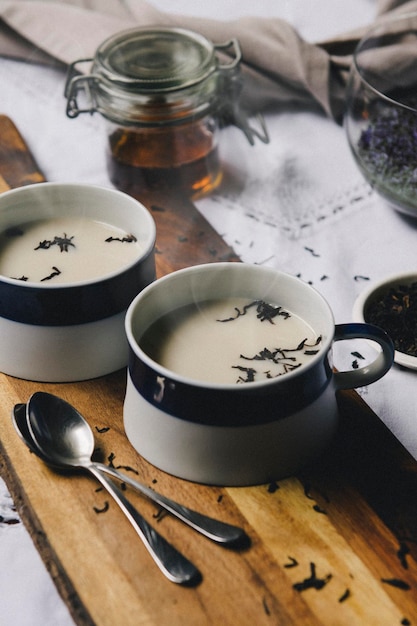 Wooden tray with cups of black tea with milk