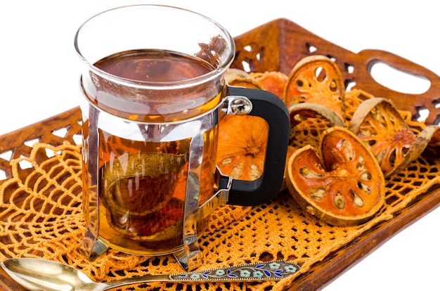 Wooden tray with dried bael fruit isolated on white surface