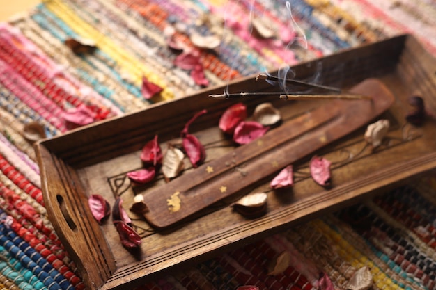 A wooden tray with a flower on it and a wooden handle with a flower on it.