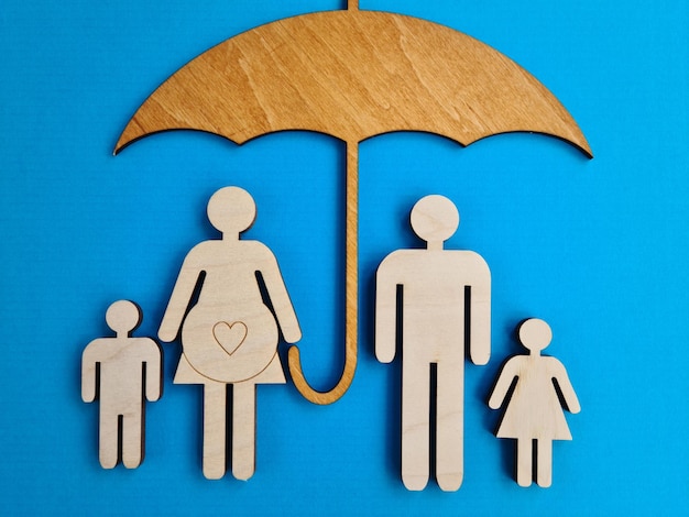 Wooden umbrella and wooden figurines of dolls family parents and children