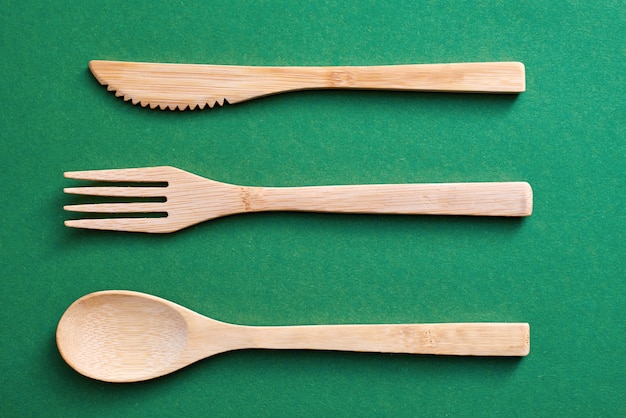 Wooden utensils on green paper 