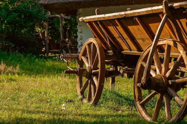 Photo wooden wagon. vintage carriage, vehicles, old farm cart with big wheels.