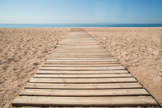 Wooden walkway in the sand on the beach