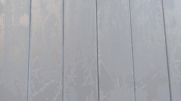 Wooden wall covered with hoarfrost on snowy winter day