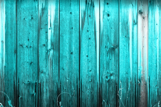 Wooden wall with a protective layer of blue paint.