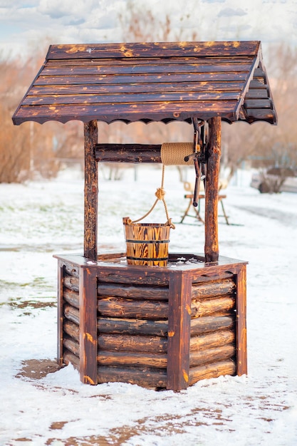 Wooden well in garden. Winter. Water well