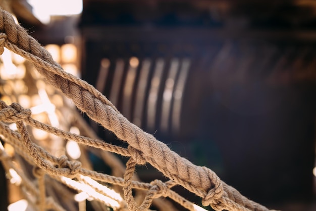 Wooden winch of a sailing ship and ropes on the deck of\
medieval pirate warship