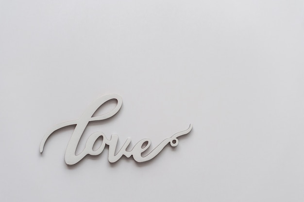 Wooden word "love" on white background. Valentines day minimal concept