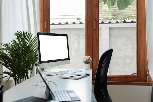 Wooden work desk with pc computer with blank screen books modern interior of cozy cabinet table for businessman or student at home comfortable workspace workplace with computer in apartment