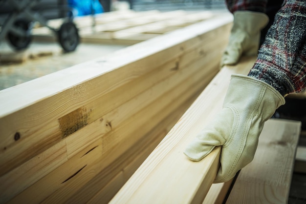 Woodworker Selecting Wood Beam For His Construction Project