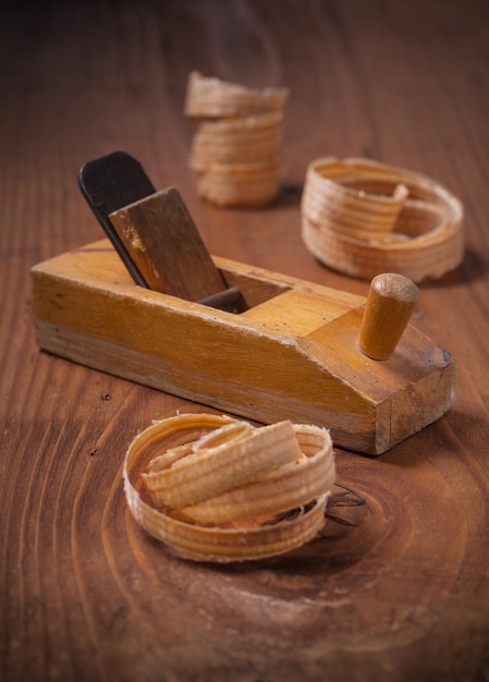 Woodworkers plane on old wooden board