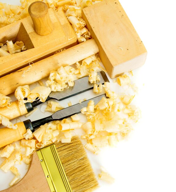 Woodworking. Joiner's works. Joiner's tools (brush, chisel, hammer) on a white background.