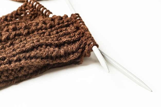 Wool and needles on a white background