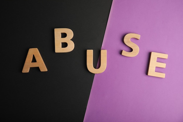 Photo word abuse on color background flat lay domestic violence awareness