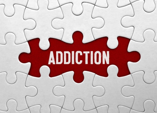 Word ADDICTION on red puzzle background