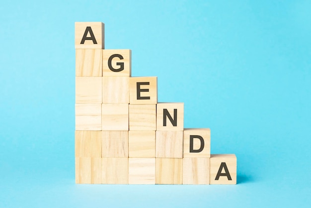 The word AGENDA is written on a wooden cubes concept