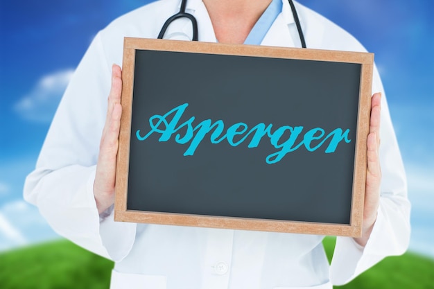 The word asperger and doctor showing chalkboard against green hill under blue sky