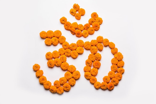 Word Aum or om made using marigold flower arrangement