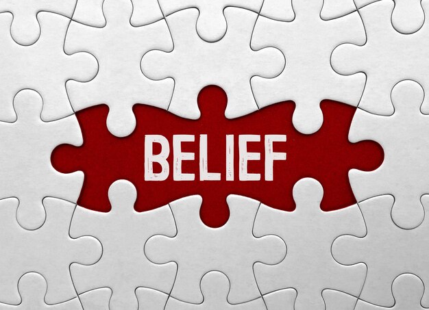 Word belief on red puzzle background