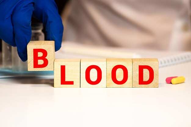 Photo word blood from wooden letters lies red backgound