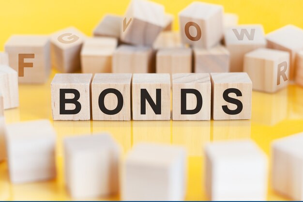 The word bonds is written on a wooden cubes structure. Blocks on a bright background. financial concept. Selective focus