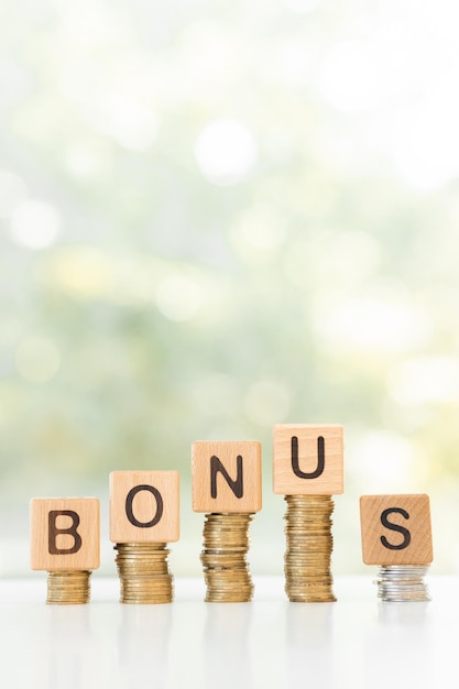 Word bonus and stack coins on green background