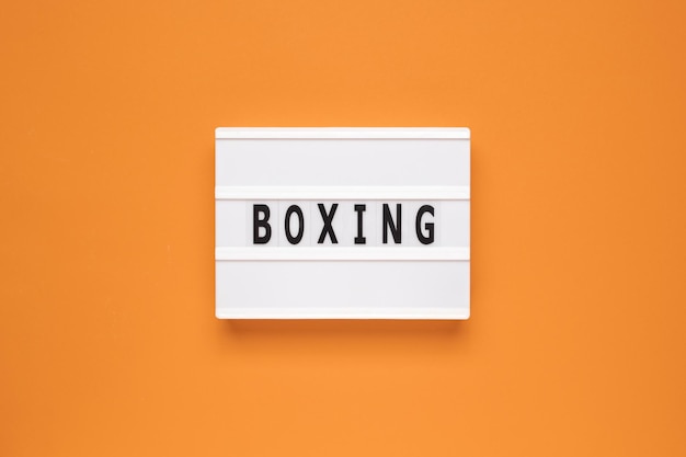 The word boxing on lightbox isolated orange background