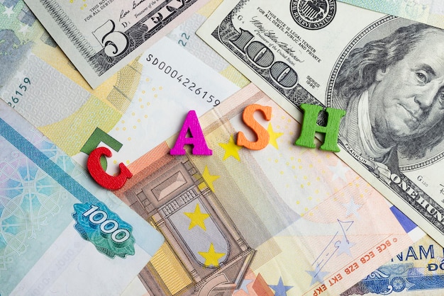 The word cash on the banknotes as a background