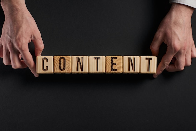 The word content on stacked wooden cubes with yellow background