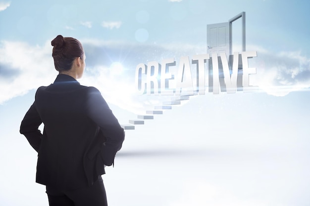 The word creative and businesswoman with hands on hips against white steps leading to open door