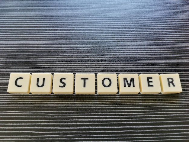 Word customer made from square letter tiles.