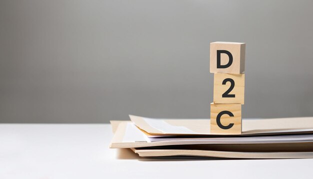 word D2C marketing on wooden cubes with documents on business table