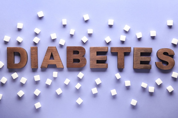 Foto word diabetes met suikerklontjes op kleur