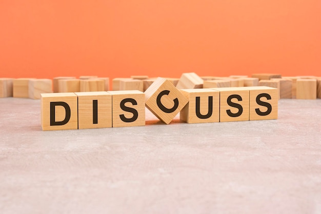 Word discuss made with wood blocks text is written in black letters light background