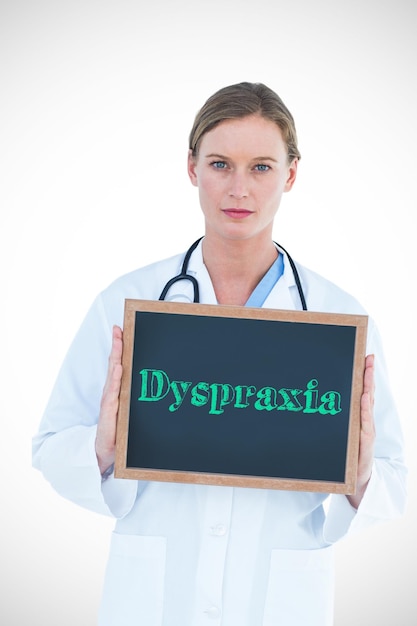 Photo the word dyspraxia against doctor showing chalkboard