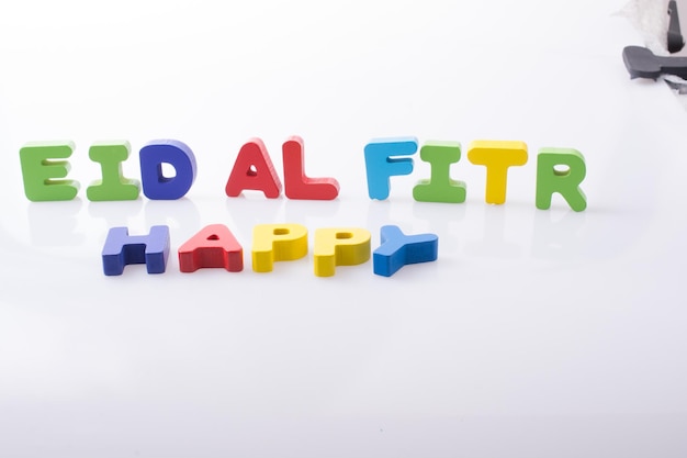 the word EID EL FITR written with colorful letters