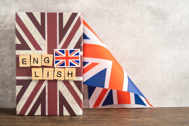 Word English on book with United Kingdom flag learning English language courses concept