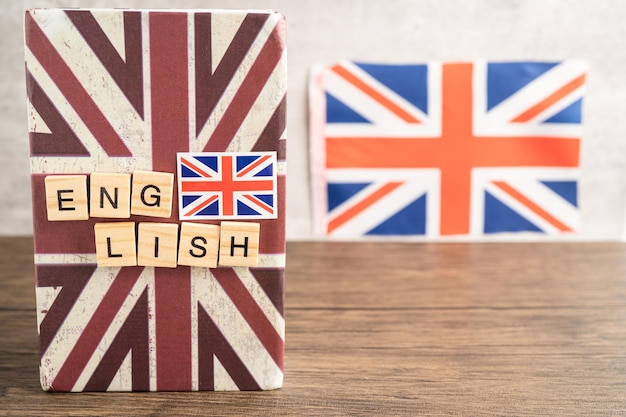 Word English on book with United Kingdom flag learning English language courses concept