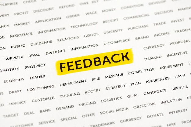 The word "Feedback" is highlighted with a marker on paper.