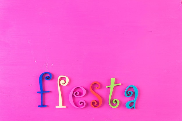 Photo word fiesta on a bright painted wood background.