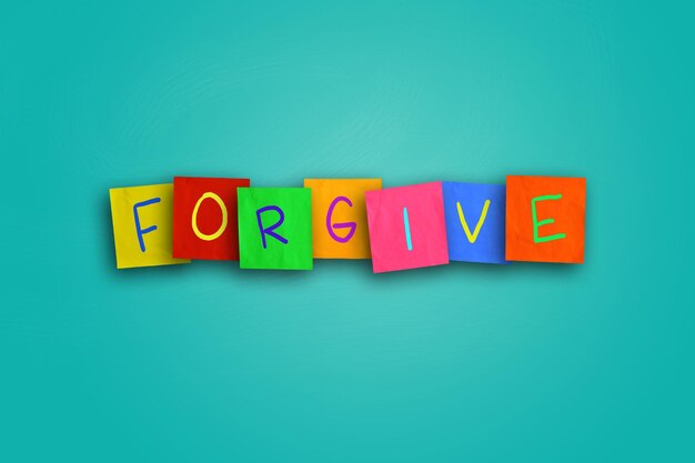 The word Forgive written on sticky colored paper